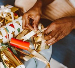 pessoa embrulhando lembrancinhas de Natal para funcionários